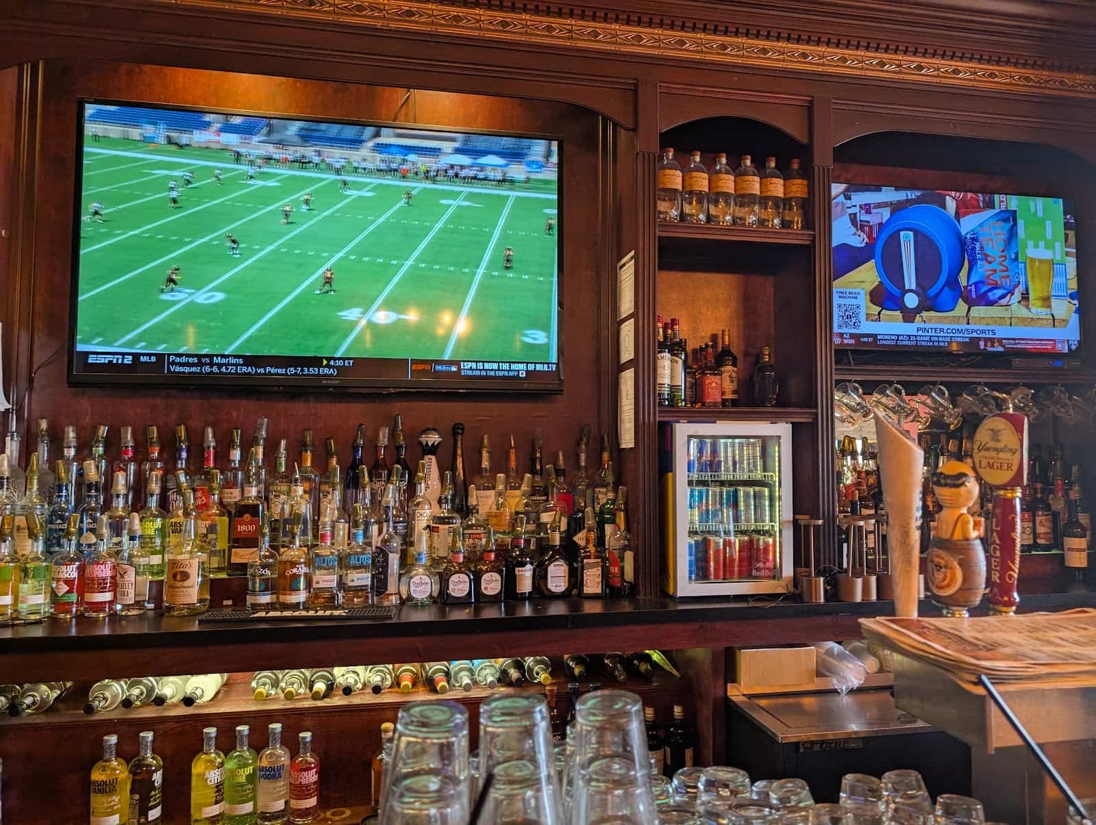 The wood back bar, bottles and screens at Cheers Bar & Bistro in Montrose