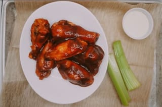 Sauced bone-in wings with celery and dipping sauce