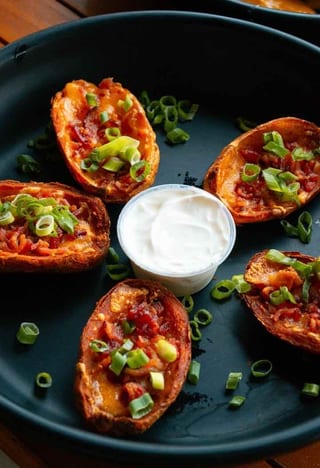 Potato Skins topped with cheese and green onions